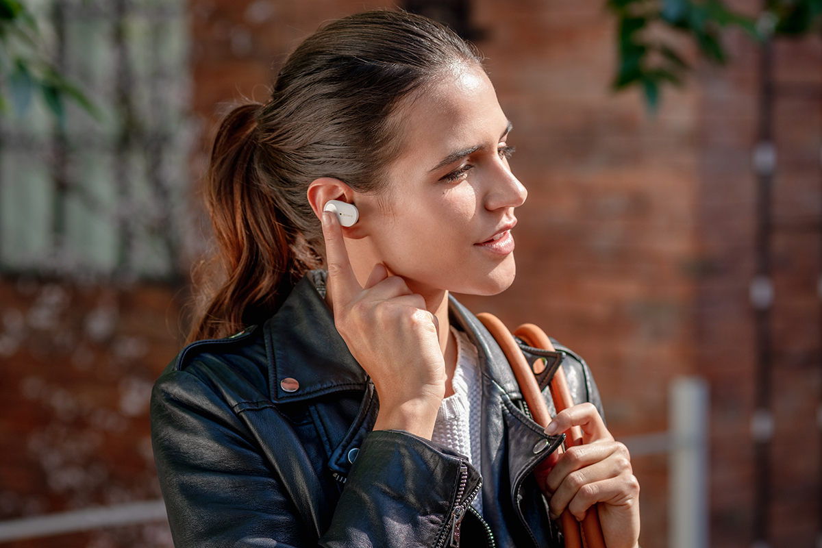image of woman with Sony 1000XM3 truly wireless headphones