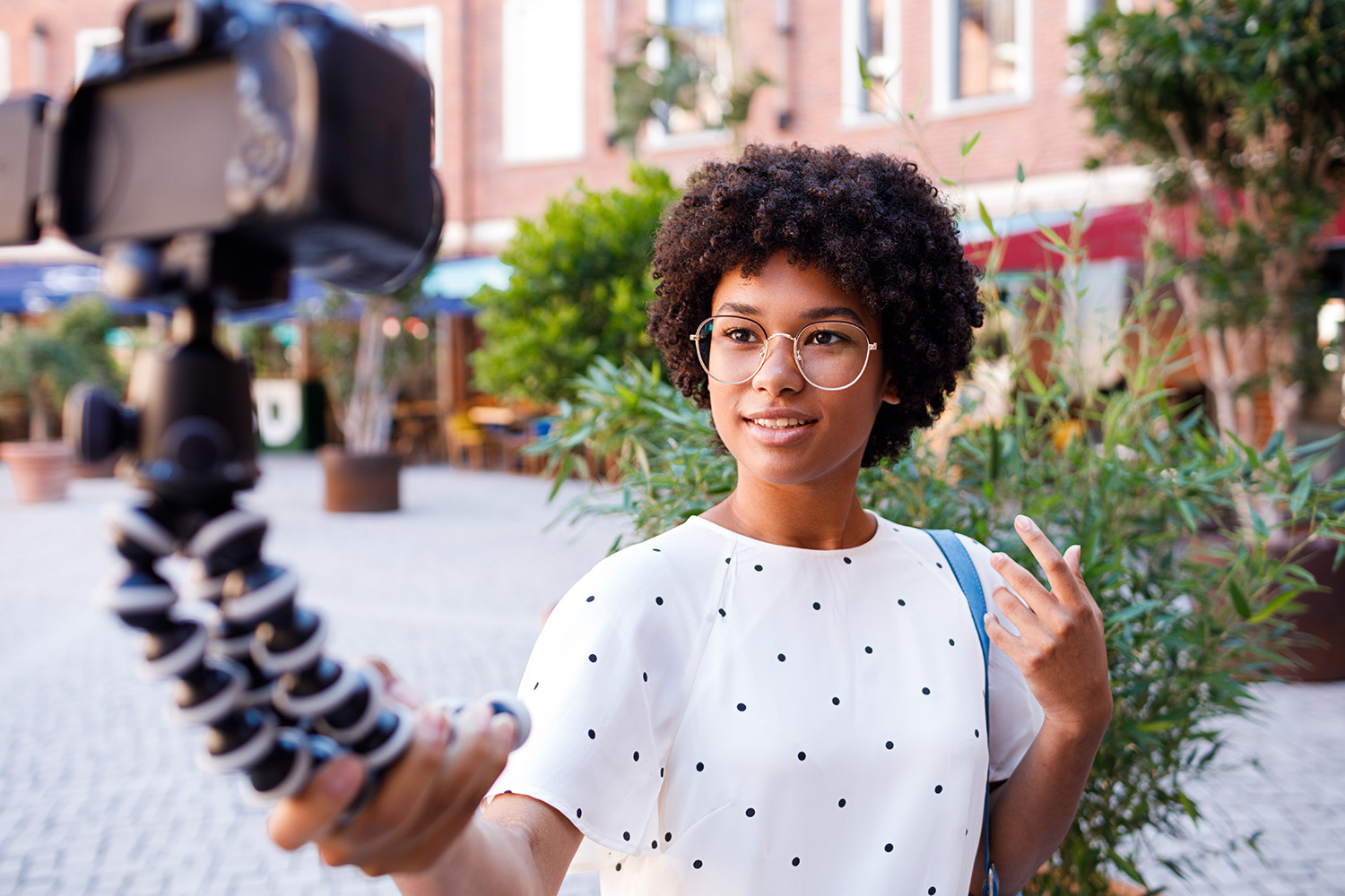 Image of a young woman in street with camera