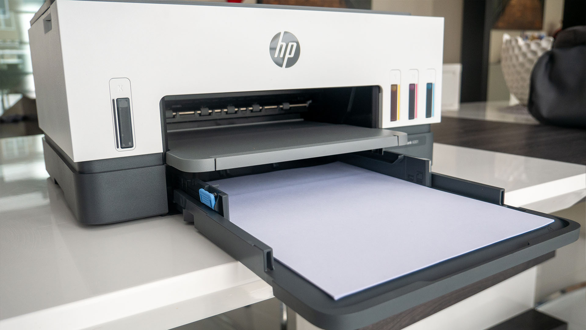 Image of HP Smart Tank 6001 printer with paper on table