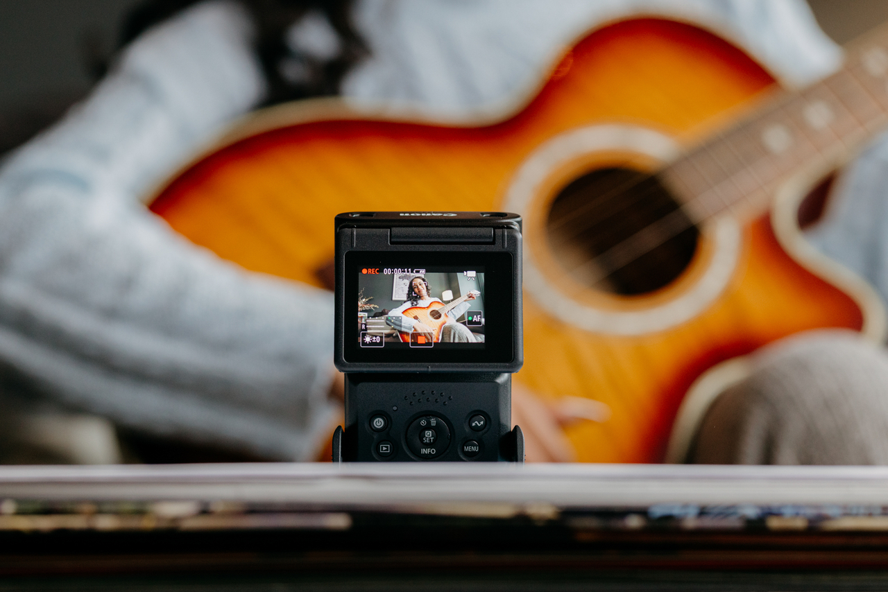 Image of PowershotV10 camera by Canon in action with guitar in background