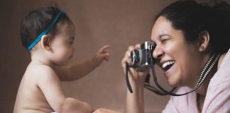 Mum photographing her baby