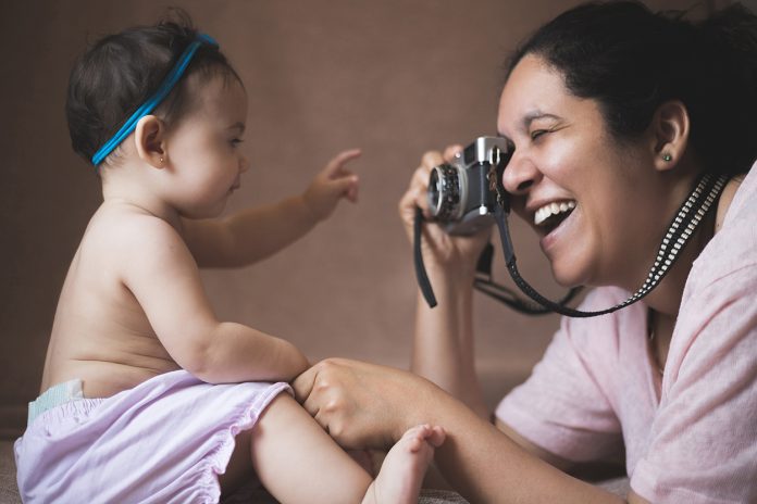 Mum photographing her baby
