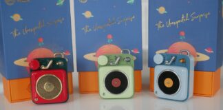 Image of Muzen Button Mini speaker with box in back