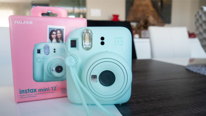 Image of Instax Mini 12 by Fujifilm with box on table