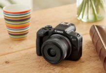 Image of Canon EOS R100 camera with lens kit on table