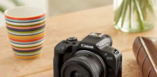 Image of Canon EOS R100 camera with lens kit on table