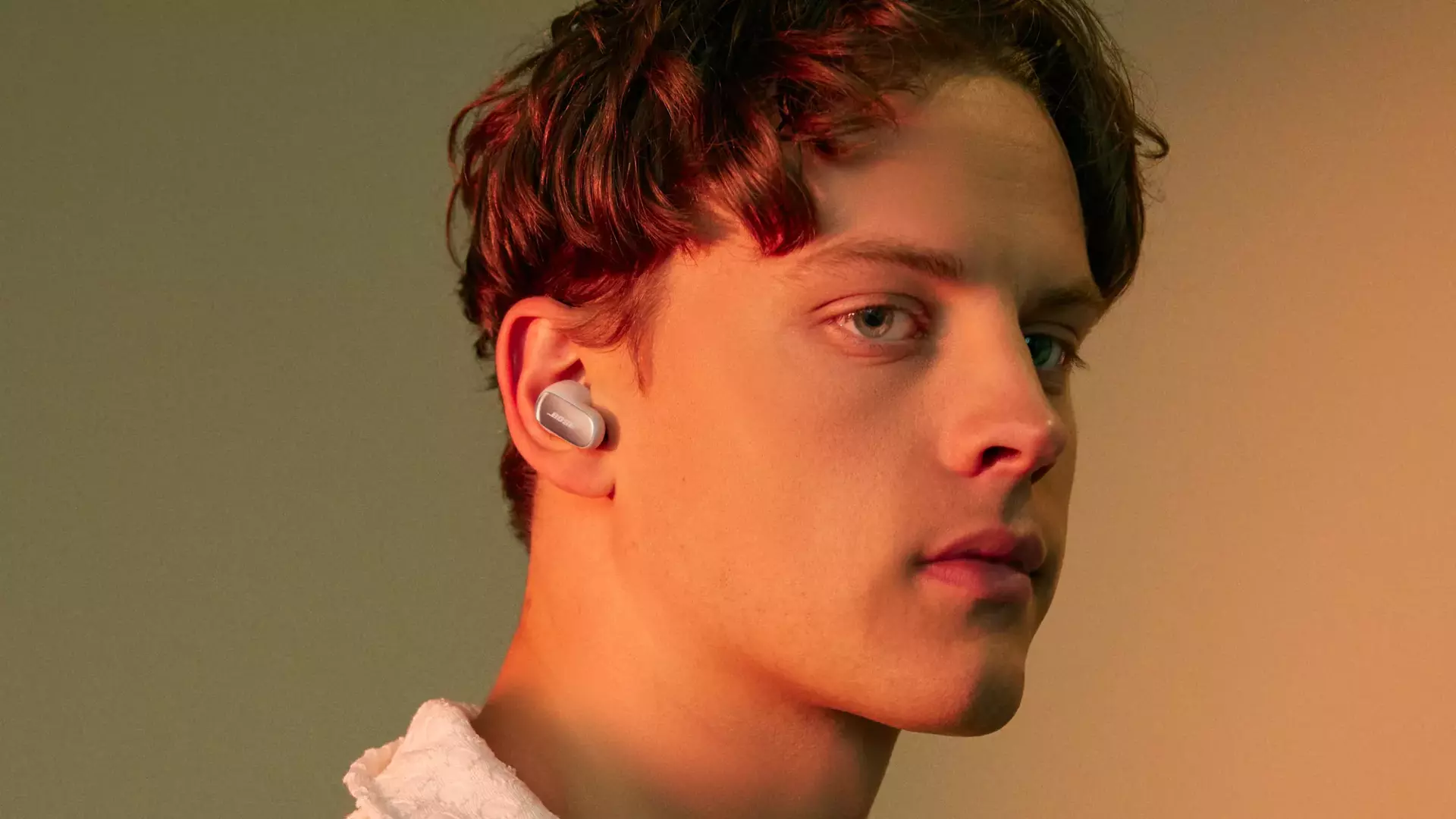 Image of men with QuietComfort Ultra earbuds by Bose