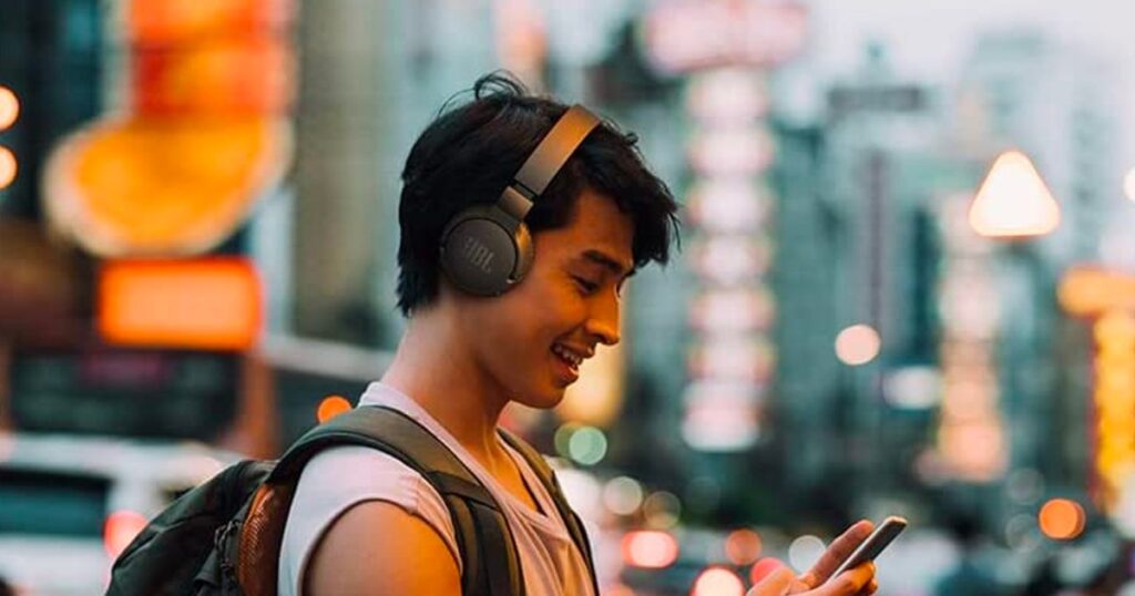 Image of a Guy using JBL Tune Headphone on street