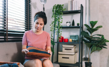 asian-young-woman-housewife-keeping-clothes-into-baskets