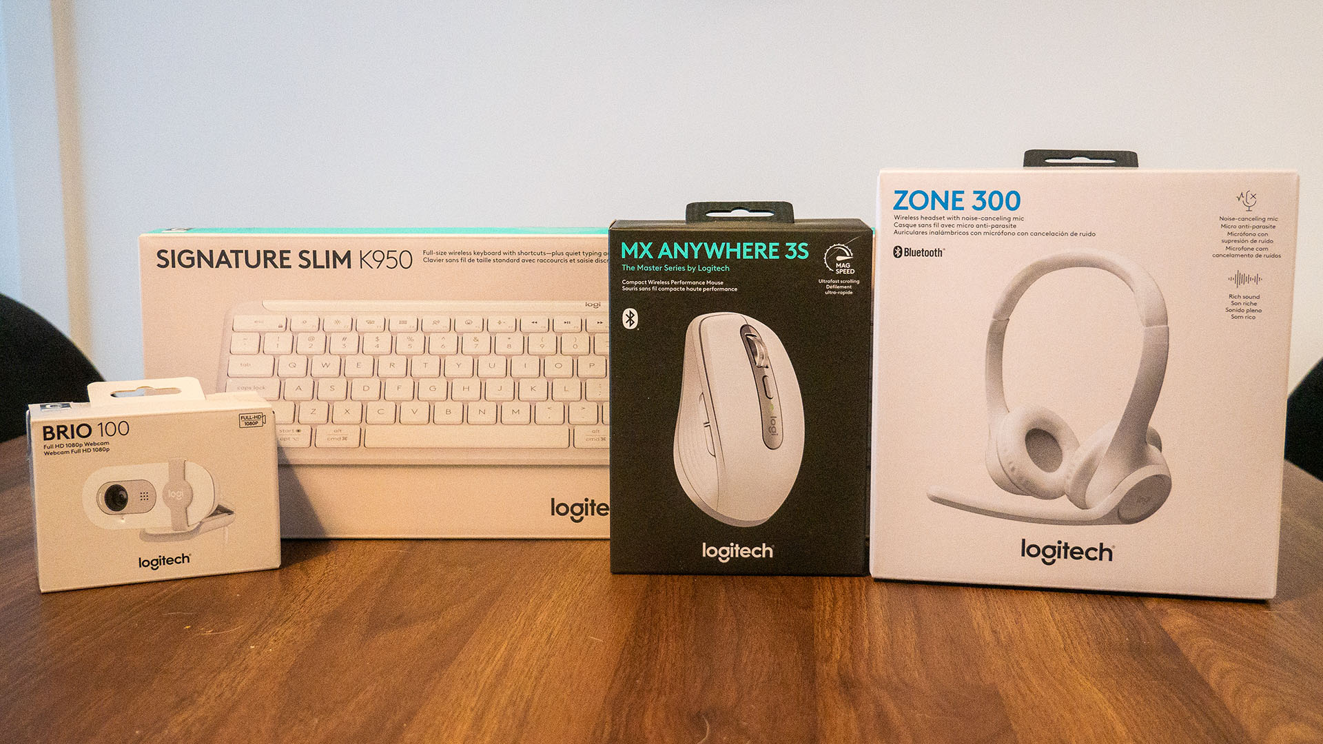 The Darkfield MX Anywhere 3S wireless mouse, the Signature Slim K950 wireless keyboard, the Brio 100 Webcam and the Zone 300 Bluetooth wireless headset in their box