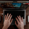 Overhead view of Logitech MX Creative Console flanking a MacBook Pro.