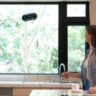 Robotic window cleaner cleaning kitchen window.