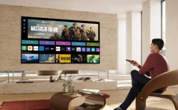 Image of guy using smart tv in saloon