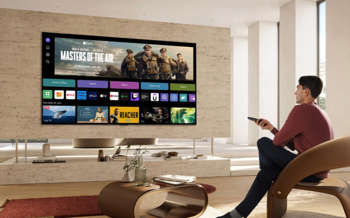 Image of guy using smart tv in saloon