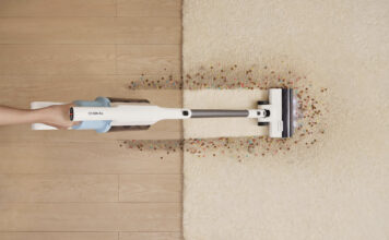 An overhead view of the Tineco Go 203 vacuum cleaning a mess on a floor and carpet.