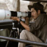 Man shooting with Sony Alpha 1 II outdoors in wildlife.