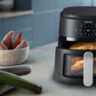 Philips 2000 Series air fryer with chicken, potatoes, and vegetables.