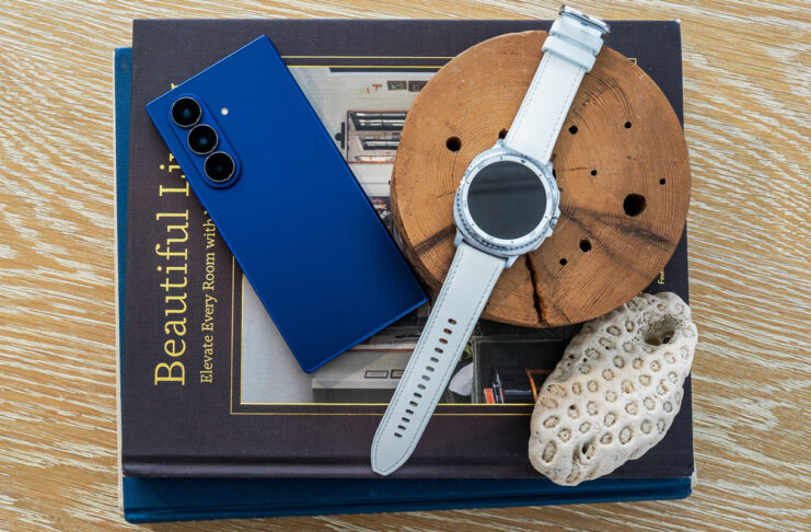 Samsung Galaxy Z Fold7 next to Galaxy Watch8 Classic on top of books.