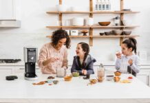mother and two daughters having fun, making ice cream together with a Ninja ice cream maker.