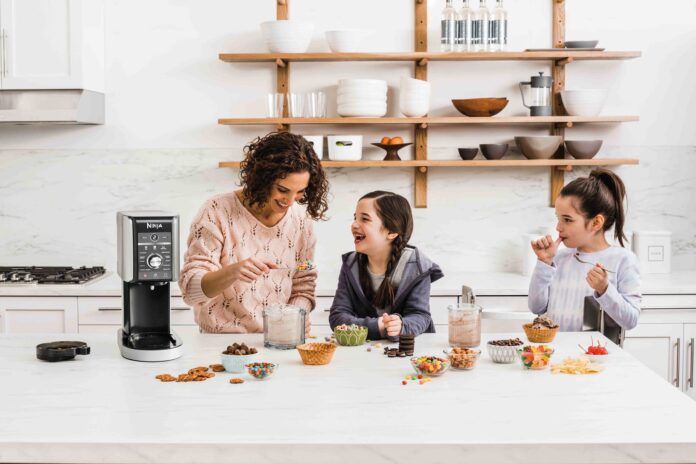 mother and two daughters having fun, making ice cream together with a Ninja ice cream maker.