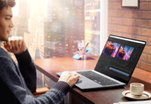 Person using laptop at a cafe