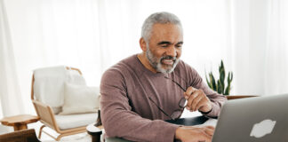 Senior men filing taxes online.
